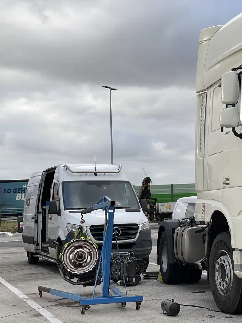 Gearbox removed from a DAF truck, hanging on our engine hoist next to the service van
