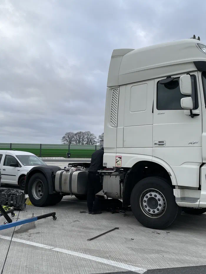 DAF truck with the front panel open, next to our engine hoist and service van